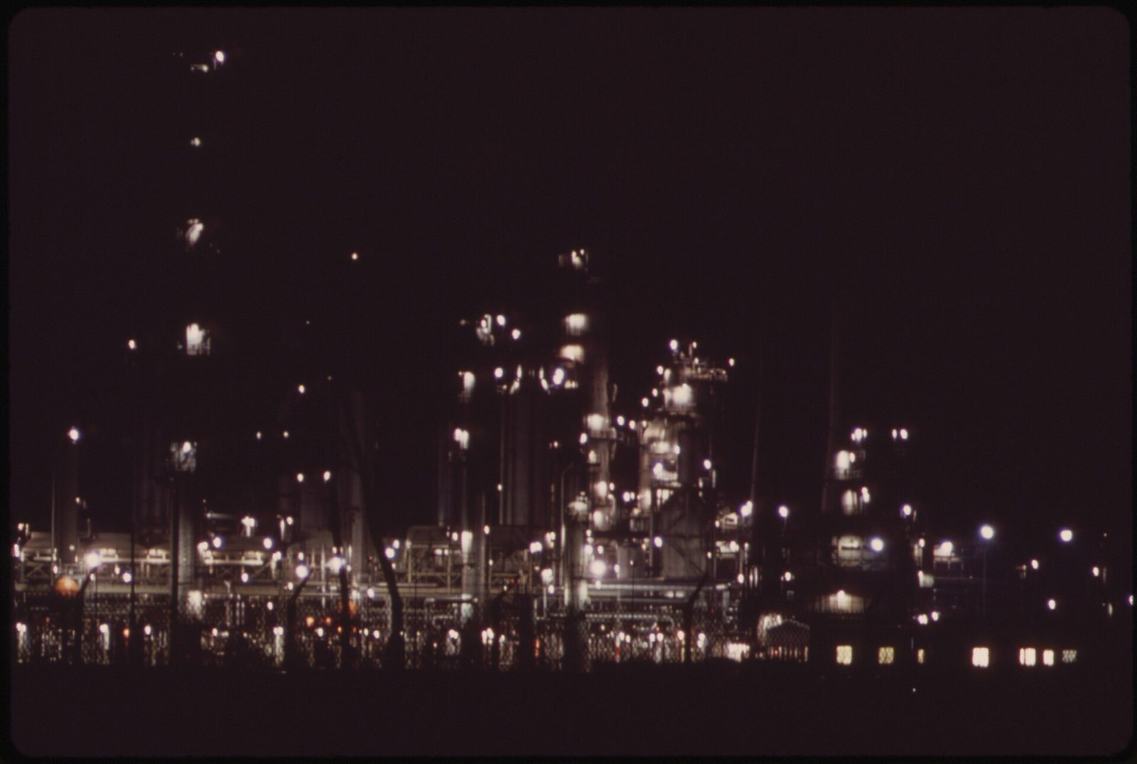 Petroleum refining plant with distillation columns and flare stacks